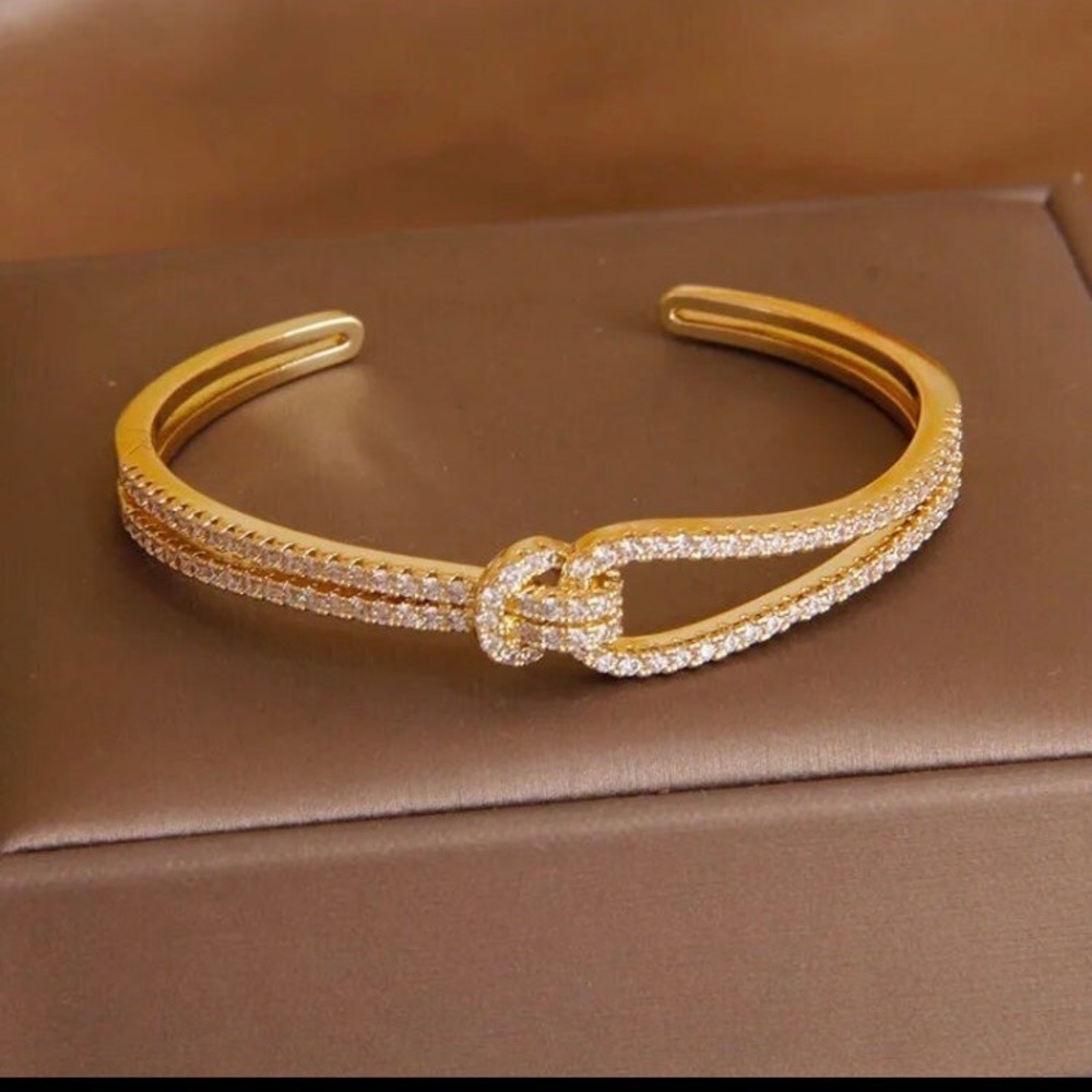 - Gold plated adjustable knot bracelet with Swarovski elements